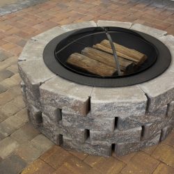 Brick paver patio with a cozy fire pit, creating a warm, inviting outdoor space